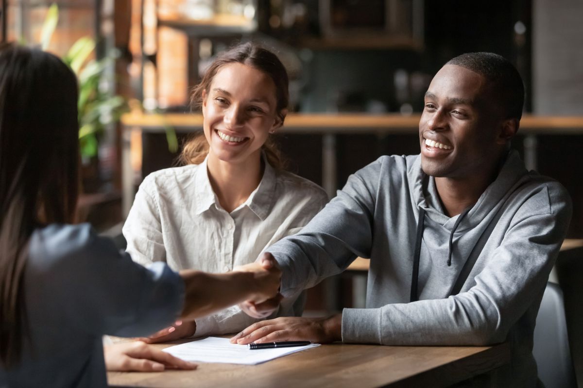 financing young couple closing deal with bank worker inside office